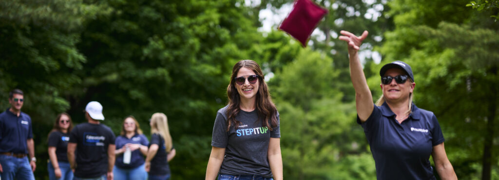 Nuspire Employees Playing Corn Hole